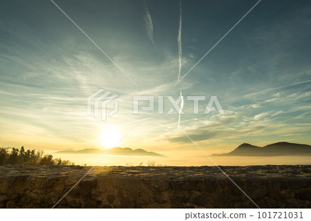 Bright orange sunset over distant mountains 101721031