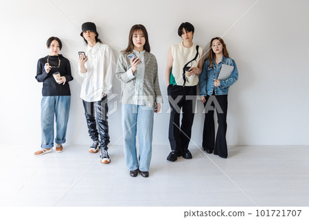 Generation Z men and women using smartphones and laptops Generation Z men and women using smartphones and laptops 101721707