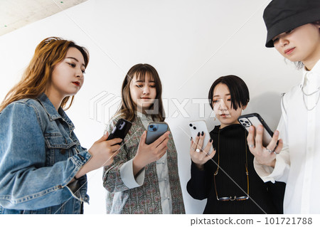 Generation Z men and women using smartphones Generation Z men and women using smartphones 101721788