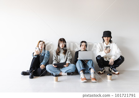 Generation Z men and women using smartphones, laptops, tablets (gadgets) Generation Z men and women using smartphones, laptops, tablets (gadgets) 101721791