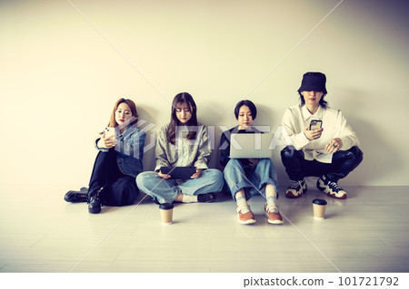 Generation Z men and women using smartphones, laptops, tablets (gadgets) 101721792