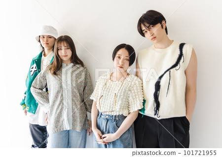 A stylish couple leaning against a white wall A stylish couple leaning against a white wall 101721955