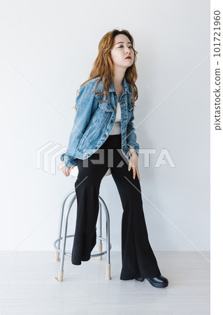 A bizarre woman sitting on a chair, brown hair, flared leg pants A bizarre woman sitting on a chair, brown hair, flared leg pants 101721960