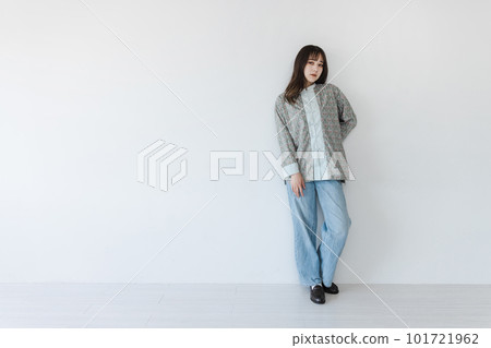 A half-Japanese young woman posing in front of a white wall A half-Japanese young woman posing in front of a white wall 101721962