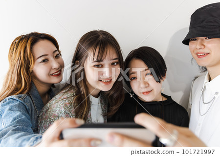Group of men and women taking pictures Group of men and women taking pictures 101721997