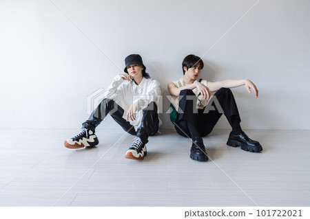 Fashionable man sitting on the white floor 101722021