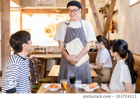 Cafe / restaurant hall staff / employee man chatting with regular customers Cafe / restaurant hall staff / employee man chatting with regular customers 101724221