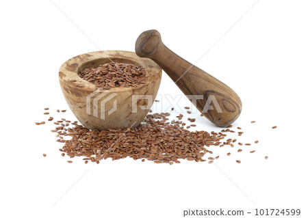 Linseed in wooden rustic-style mortar on white 101724599