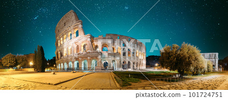 Rome, Italy. Colosseum Also Known As Flavian Amphitheatre In Evening Or Night Time. Travel Italy. Bright Blue Night Sky. Amazing Night Starry Sky Background. Panoramic View 101724751