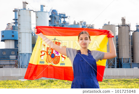 Concentrated young woman holds the national flag of Spain 101725848