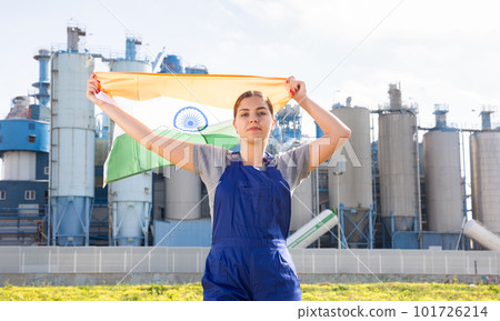 Smiling young woman near factory with India flag 101726214