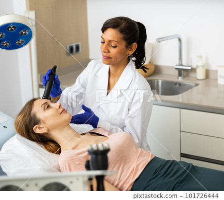 Woman receiving face ultrasound lifting procedure 101726444