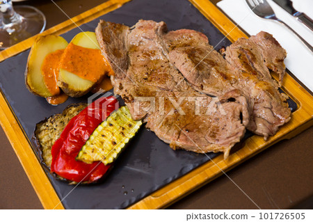 Beef steak with baked potatoes, vegetables, romesco 101726505