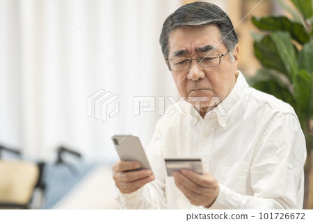 Senior man shopping online using credit card Senior man shopping online using credit card 101726672