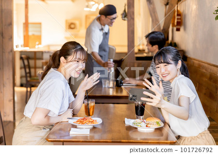 A young Japanese woman taking a selfie at a cafe/restaurant/restaurant A young Japanese woman taking a selfie at a cafe/restaurant/restaurant 101726792