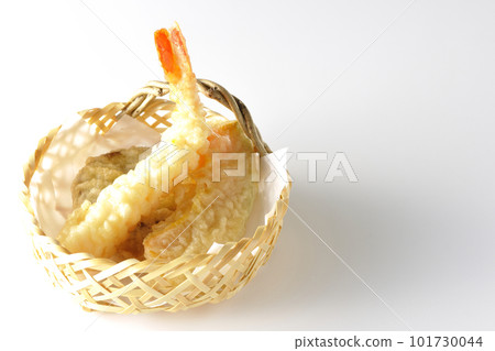Assorted sweet potato, shrimp, and pumpkin tempura shot against a white background 101730044