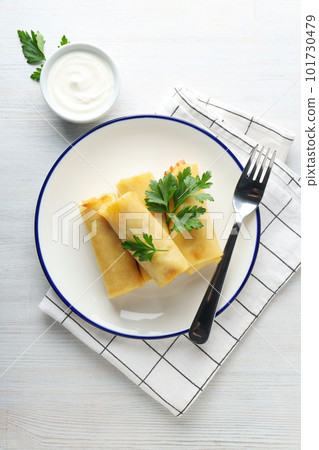 Concept of tasty food, thin pancakes with filling, top view Concept of tasty food, thin pancakes with filling, top view 101730479