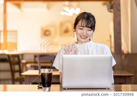 Business woman waving and greeting at web conference, remote conference, videophone Business woman waving and greeting at web conference, remote conference, videophone 101730998