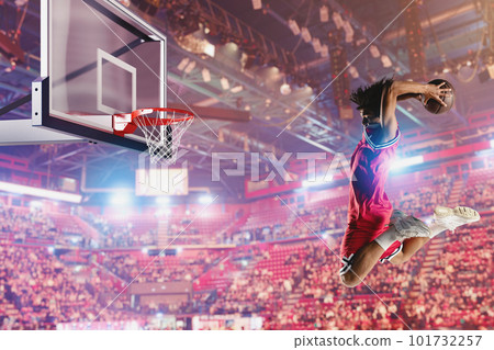 Basketball player jumping to make a basket during a match 101732257