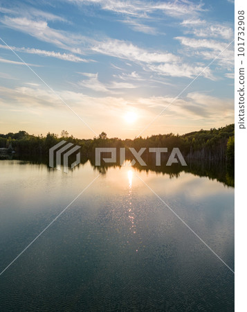 Aerial panorama Early Sunrise over forest lake. Noctilucent night clouds, summer foggy lake reflects 101732908
