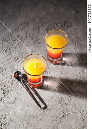 Shot with orange taste, tasty citrus shot concept Shot with orange taste, tasty citrus shot concept 101733178