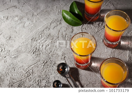Shot with orange taste, tasty citrus shot concept Shot with orange taste, tasty citrus shot concept 101733179