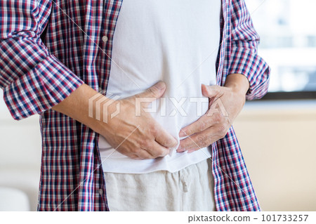 Hands and belly of a man holding his stomach Hands and belly of a man holding his stomach 101733257