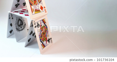 House of stacked playing cards against a white background with room for text placement 101736104