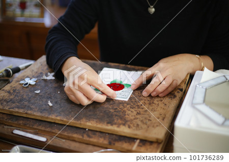 A woman making a stained glass work A woman making a stained glass work 101736289