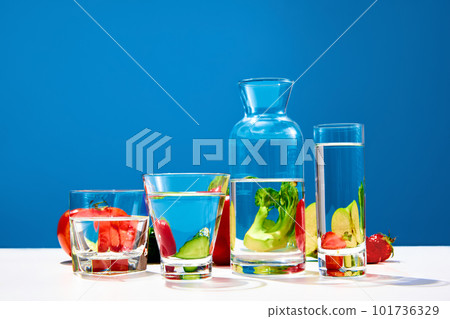 Still life with fresh vegetables broccoli pepper, cucumber, strawberry over blue studio background. Organic food Still life with fresh vegetables broccoli pepper, cucumber, strawberry over blue studio background. Organic food 101736329