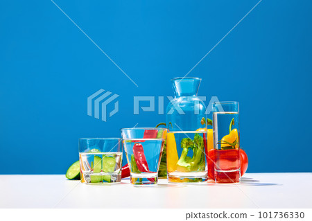 Fresh vegetables broccoli pepper, cucumber over blue studio background. Bright yellow, green, red vitamins for salad. Healthy diet composition 101736330