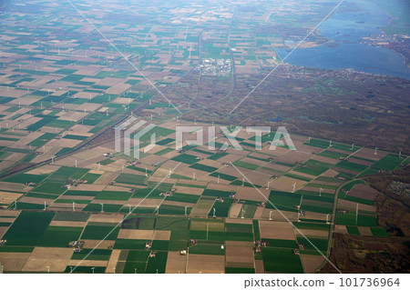 aerial view of wind farm Multiple wind turbines generating eco friendly green energy for a better environment. fields next to a canal Waalwijk, Noord-Brabant, Netherlands. aerial view of wind farm Multiple wind turbines generating eco friendly green energy for a better environment. fields next to a canal Waalwijk, Noord-Brabant, Netherlands. 101736964