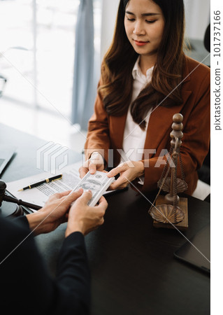 justice and law concept.passing bribe money in the envelop at office. businessman hand taking bribe money from female justice and law concept.passing bribe money in the envelop at office. businessman hand taking bribe money from female 101737166