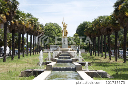 Golden Athena statue and fountain in a tropical space near Porte Dorée metro station on line 8 and tram, Paris Golden Athena statue and fountain in a tropical space near Porte Dorée metro station on line 8 and tram, Paris 101737373