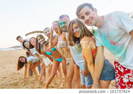 Teenagers Friends have fun at the holi festival. Beach Party. Celebrating traditional indian spring holiday. Teenagers Friends have fun at the holi festival. Beach Party. Celebrating traditional indian spring holiday. 101737924