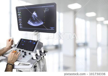 Ultrasound or sonogram procedure. Doctor hand holding an ultrasound sensor. Ultrasound examination.Screen of an ultrasound machine with a heart image. Ultrasound or sonogram procedure. Doctor hand holding an ultrasound sensor. Ultrasound examination.Screen of an ultrasound machine with a heart image. 101738336