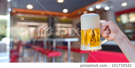 Hand shows a glass of beer with foam . Hand shows a glass of beer with foam . 101738582
