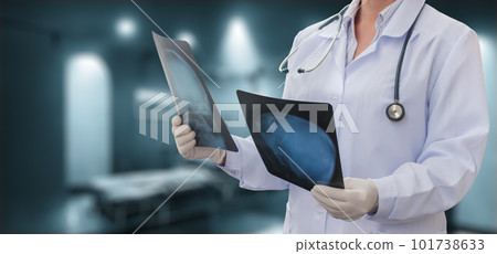 The doctor examines x-rays in the  room. 101738633