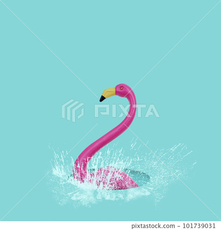 fake pink flamingo in a puddle of water fake pink flamingo in a puddle of water 101739031