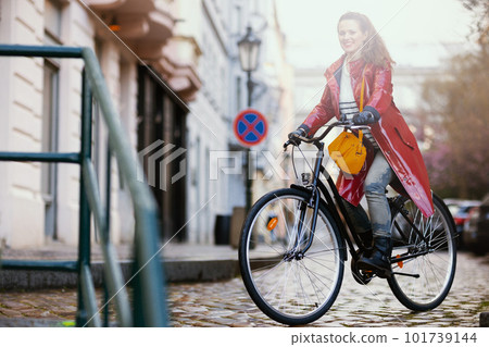 happy stylish woman outdoors on city street riding bicycle happy stylish woman outdoors on city street riding bicycle 101739144