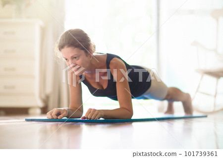Yoga exercise at home. Fit woman stretching on mat 101739361
