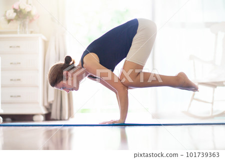 Yoga exercise at home. Fit woman stretching on mat 101739363