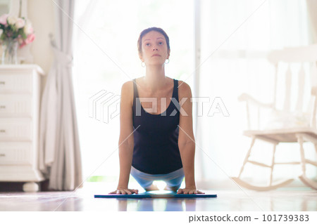 Yoga exercise at home. Fit woman stretching on mat 101739383