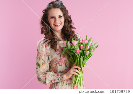happy young woman with long wavy brunette hair on pink 101739759