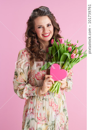 smiling modern woman in floral dress on pink smiling modern woman in floral dress on pink 101739761