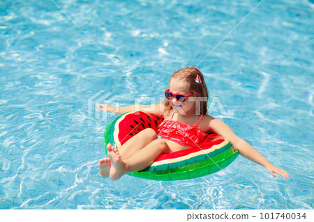 Child in swimming pool. Kids swim. Water play. 101740034