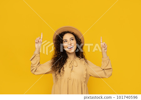 Young woman in dress on yellow background Young woman in dress on yellow background 101740596