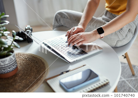 Young woman designer or freelancer working at home using computer sitting at table at home Young woman designer or freelancer working at home using computer sitting at table at home 101740740
