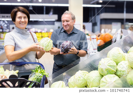 husband and wife choose cabbage in vegetable department husband and wife choose cabbage in vegetable department 101740741