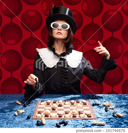 Lord of chocolate. Stylish woman in cylinder hat and sunglasses playing chess with candie figures against red pattern background Lord of chocolate. Stylish woman in cylinder hat and sunglasses playing chess with candie figures against red pattern background 101740879